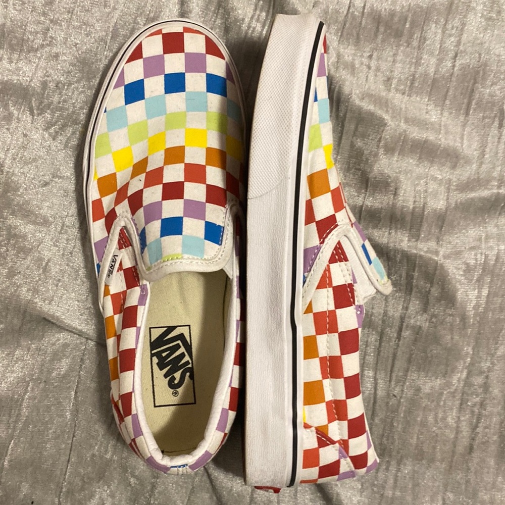Multi colored slip on vans.